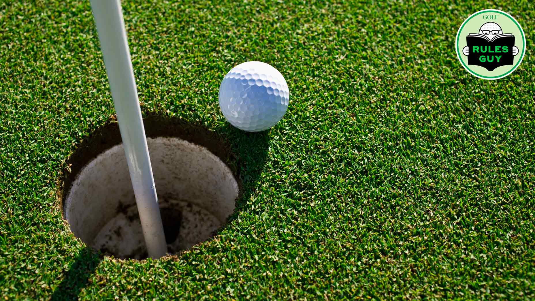 golf ball next to hole