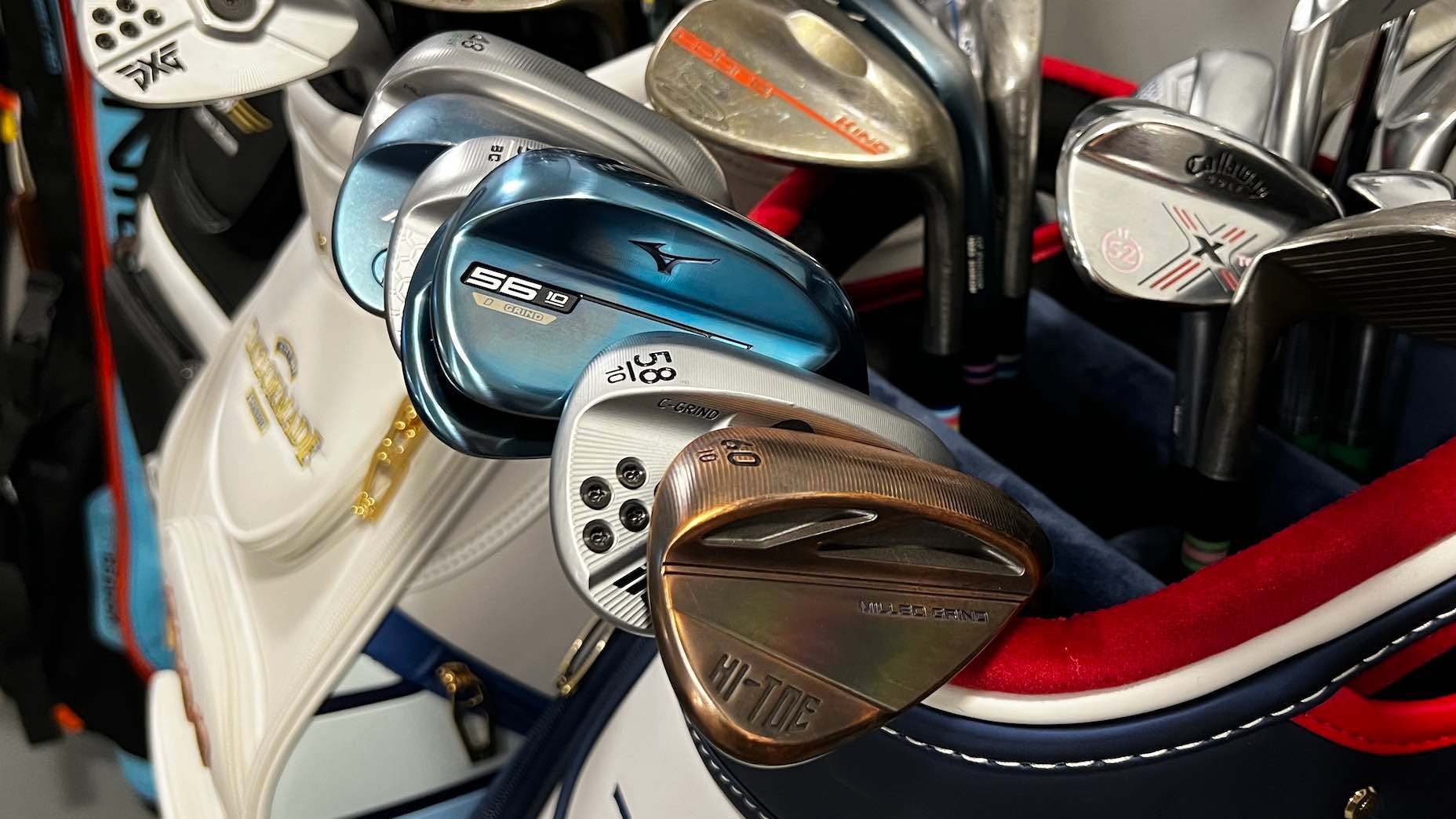 A golf bag with several golf clubs protruding from it
