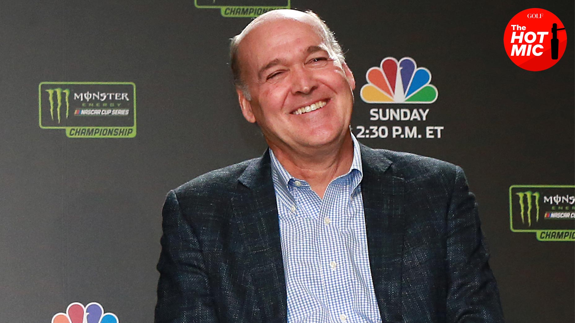 sam flood smiles in NBC indycar press conference in suit jacket and blue shirt