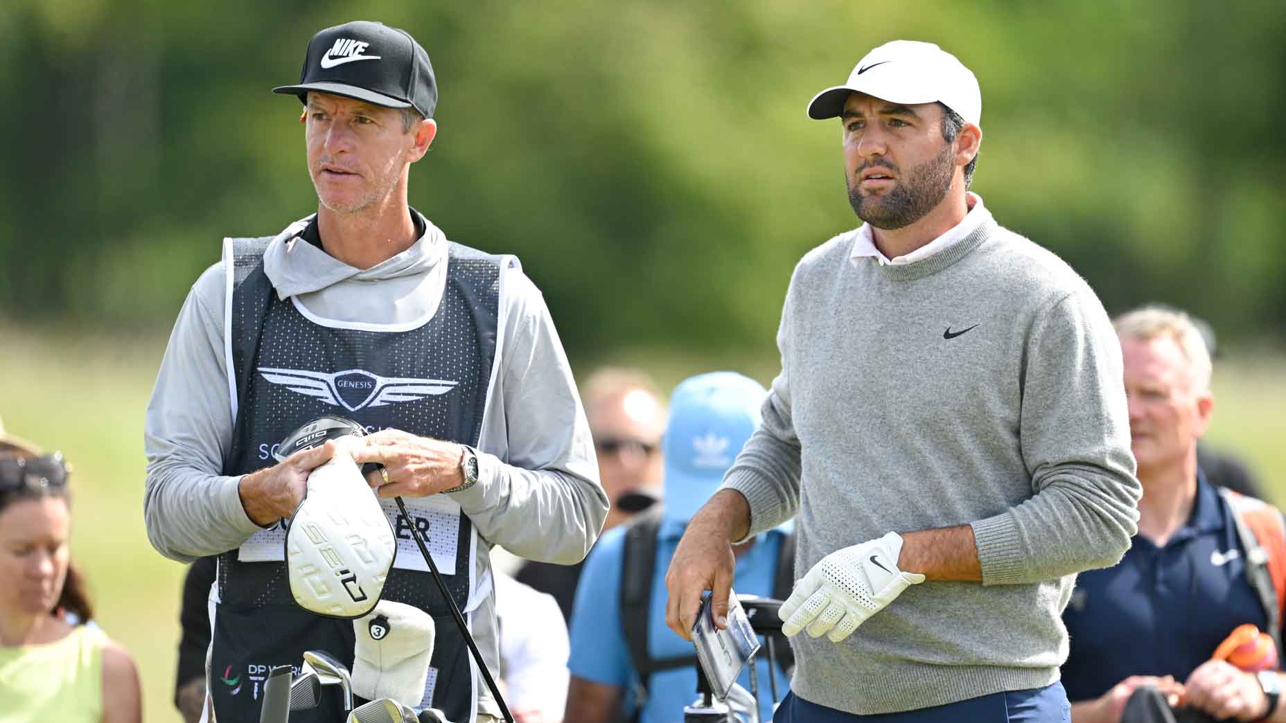 PGA Tour pro Scottie Scheffler stands with his caddie during the 2025 Genesis Scottish Open.